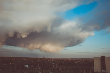 Storm clouds above the ground. Art processing. Storm clouds and sky.