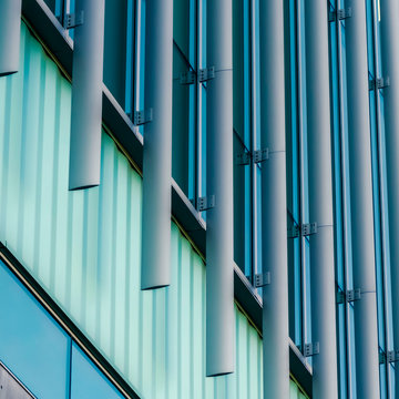 Clear Square Exterior of a modern building with vertical sunshades outside the glass windows