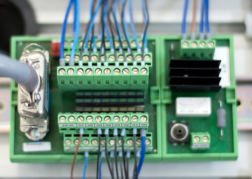 Blurred and de-focus electrical terminal block ( connector ) with wires on the electronic board.