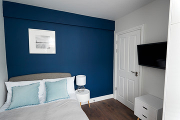 Modern bedroom, looking across bed towards door