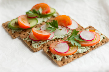 delicious diet sandwiches with cottage cheese with herbs and vegetables on a white background