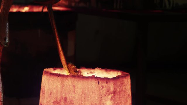 metal slough gets pulled out of crucible while heating bronze