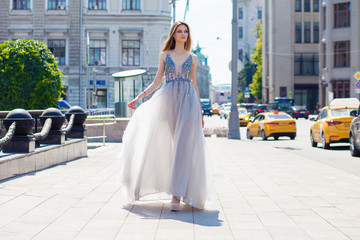 Obraz premium Young beautiful blonde woman in summer white dress