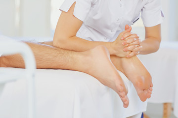 Obraz na płótnie Canvas Foot massage.Masseur massage the client.