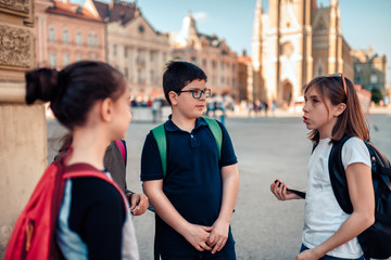 Kids hang out on town square after school © kerkezz