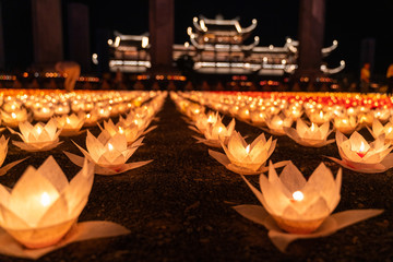 Colored lanterns and garlands at night on Vesak day for celebrating Buddha's birthday in Eastern culture, that made from paper and candle