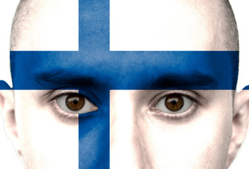National flag Finland colored depicted in paint on a man's face close-up, isolated on a white background
