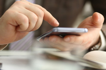 Male arm in suit hold phone and silver pen at workplace closeup. Read news mania send sms chat addict use electronic bank modern lifestyle job plan colleague share blog tweet web application search