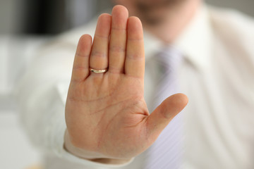 Male arm show palm during conference conversation as no in office closeup. Suggestion refuse solution argument illustrate offer proposition bribe demand keep out protect service high five concept