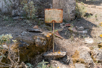 old rusty information sign in a ruin