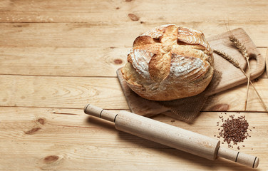 Freshly baked bread on wooden background. Bread at leaven. Unleavened bread.