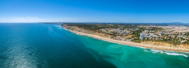 Aerial seascape, of Praia Porto de Mos (Beach and seaside cliff formations along coastline of Lagos city), famous destination in Algarve. South Portugal.