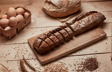 Freshly baked bread .Top view of sliced wholegrain bread on dark ructic wooden  background closeup. Bread at leaven. Unleavened bread.