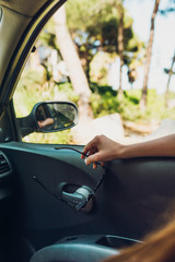 Naklejka premium Girl resting her hands on the car window