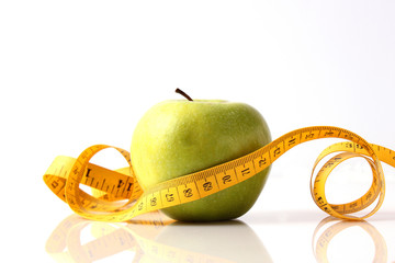 apple and measuring tape isolated on white.