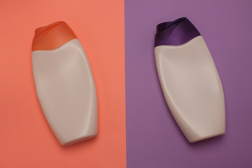 Beauty, decorative cosmetics bottles. Peach and purple colors background, flat lay, top view, minimalistic pop-art style