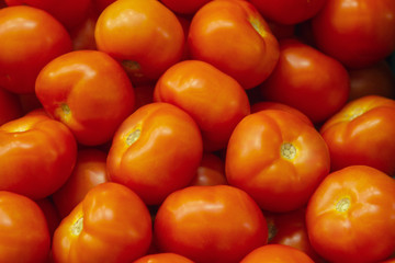 Fresh red tomato lying on the market counter. Red tomatoes texture, bright healthy vegetables and vegetatarian texture of red tomatos