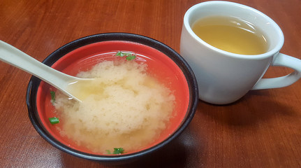 Miso soup served with a cup of green tea