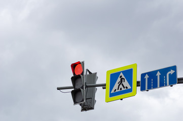 Red color at the traffic lights. Sign of the pedestrian crossing.