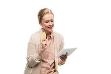 smiling middle aged woman with credit card using Digital Tablet Isolated On White