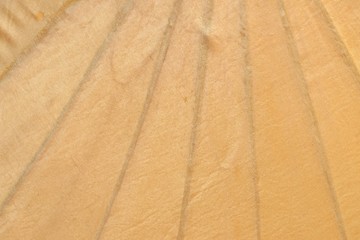 Close up yellow umbrella detail with a fabric pattern for background backdrop 