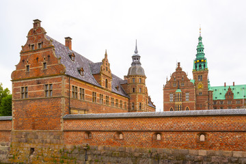 Fototapeta premium Facade of the Royal palace Frederiksborg Slot in Dutch Renaissance style in Hillerod. It was built as a royal residence for King Christian IV and is now a museum of national history.