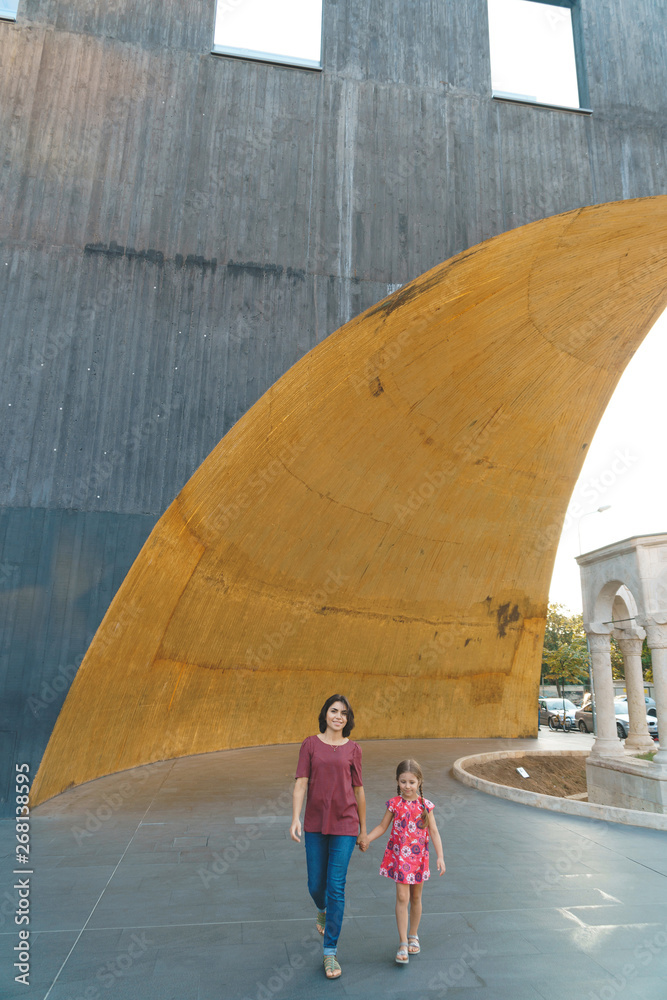 Wall mural mother and daughter under arch of building