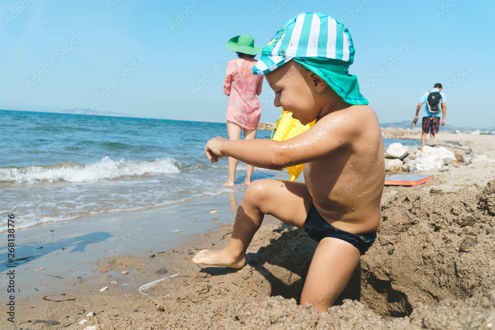 Wall mural boy playing in sand