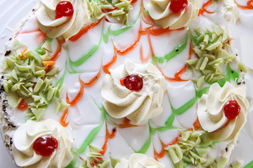 Traditional sweet birthday cake with colorful candles.