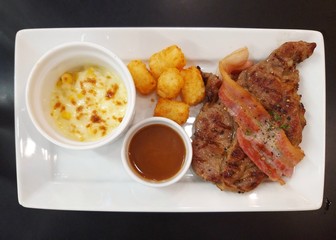 Pork steak with bacon and snack