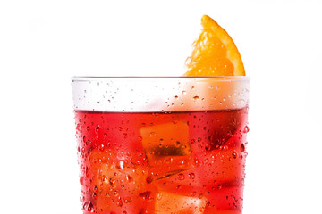 Negroni cocktail with piece of orange in glass isolated on white background