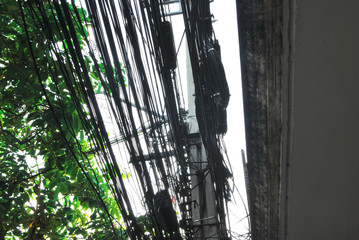 Power lines and cables that are cluttered on electric poles