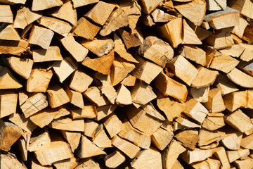 A lot of chopped firewood lie together in a bundle.