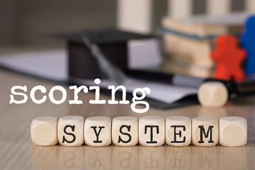 Words SCORING SYSTEM composed of wooden dices.