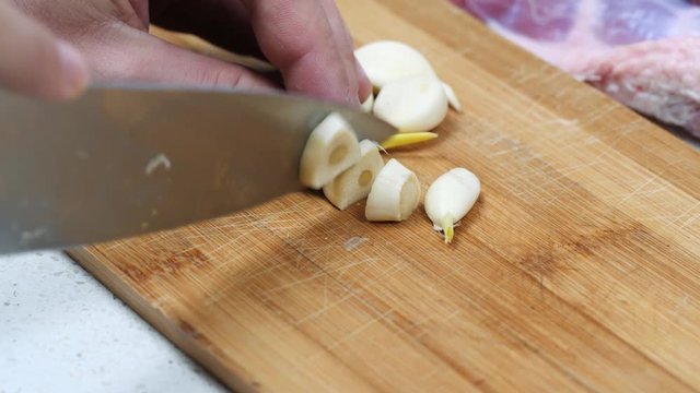 Cutting garlic on a wooden board