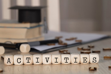 Word ACTIVITIES composed of wooden dices.