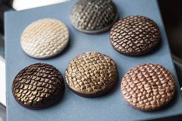 Baking polymer clay charms on blue tile