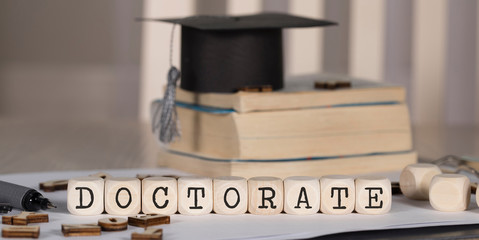 Word DOCTORATE composed of wooden dices.