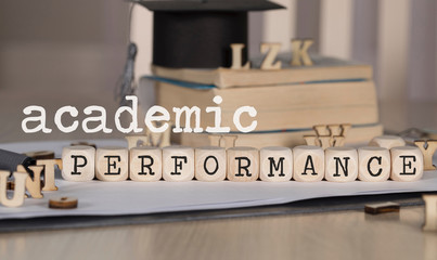 Words ACADEMIC PERFORMANCE composed of wooden dices.