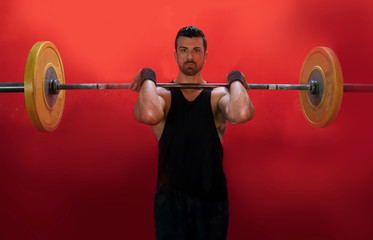 man lifting a barbell at the crossfit gym