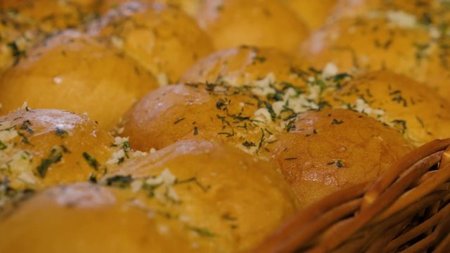 Fresh breakfast bakery goods. Fresh baked garlic buns at a bakery, close up.