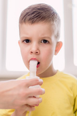 mother treats bronchitis in a child with a nebulizer