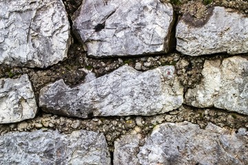 Retaining stone wall next to the road.Steel mesh of gabion wall.