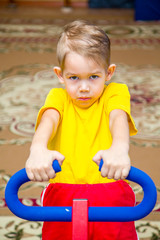 boy in a yellow t-shirt on a sports simulator