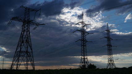 Electricity pylons and the storm clouds on the background