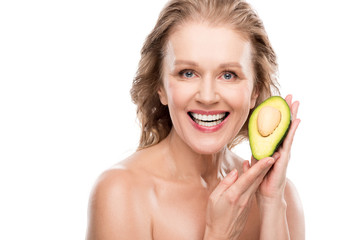 beautiful smiling nude middle aged woman posing with avocado Isolated On White