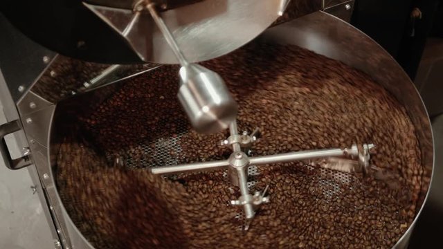 The iron wheel is spinning coffee beans