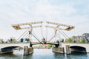 Naklejka premium Amsterdam, Netherlands September 5, 2017: Magere Brug Bridge and Amstel river.