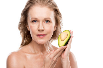 beautiful nude middle aged woman posing with avocado Isolated On White