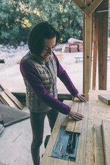 A woman works in a carpentry workshop.